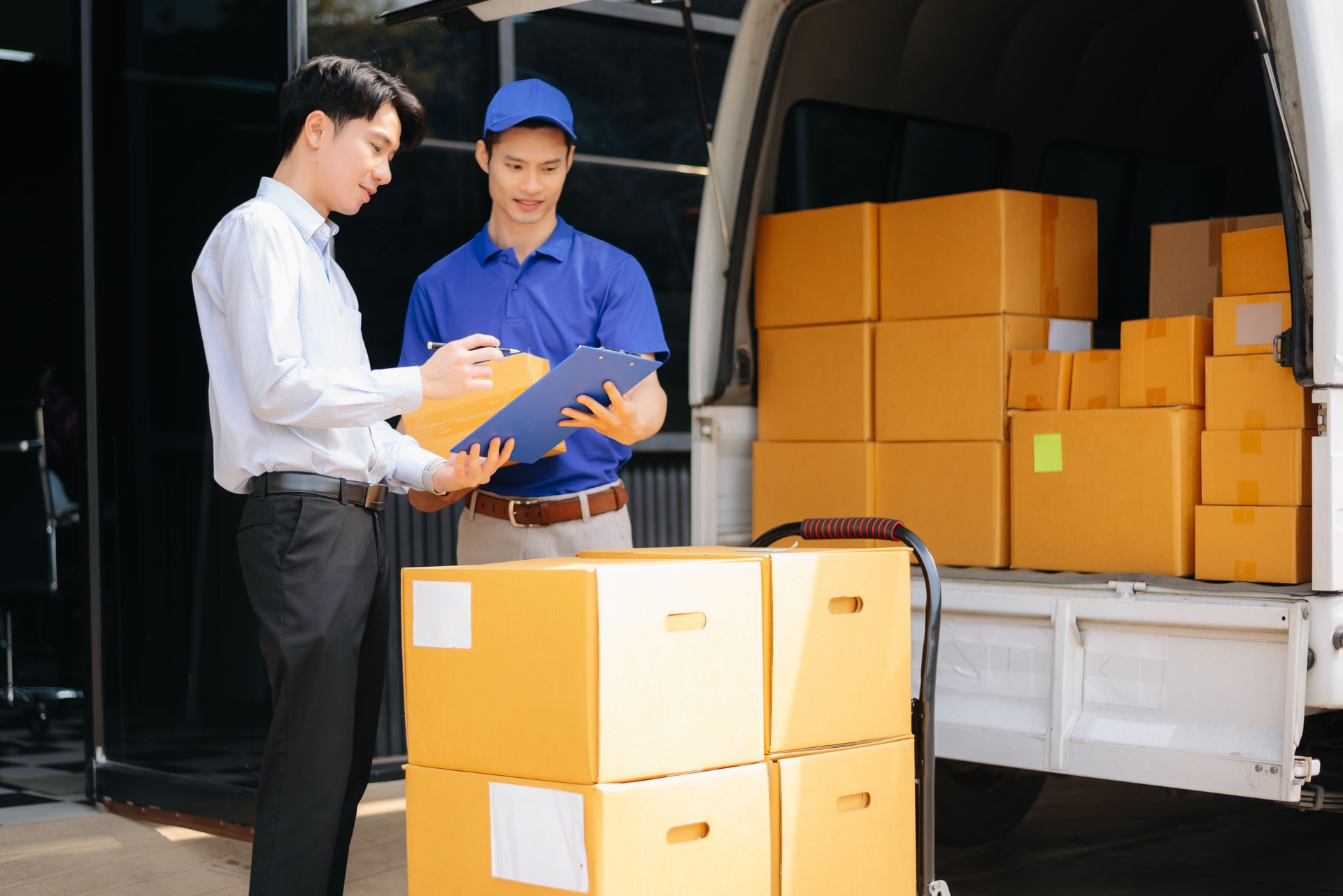Asian Courier Delivering Package to man Delivery service near van outside the warehouse, delivery home